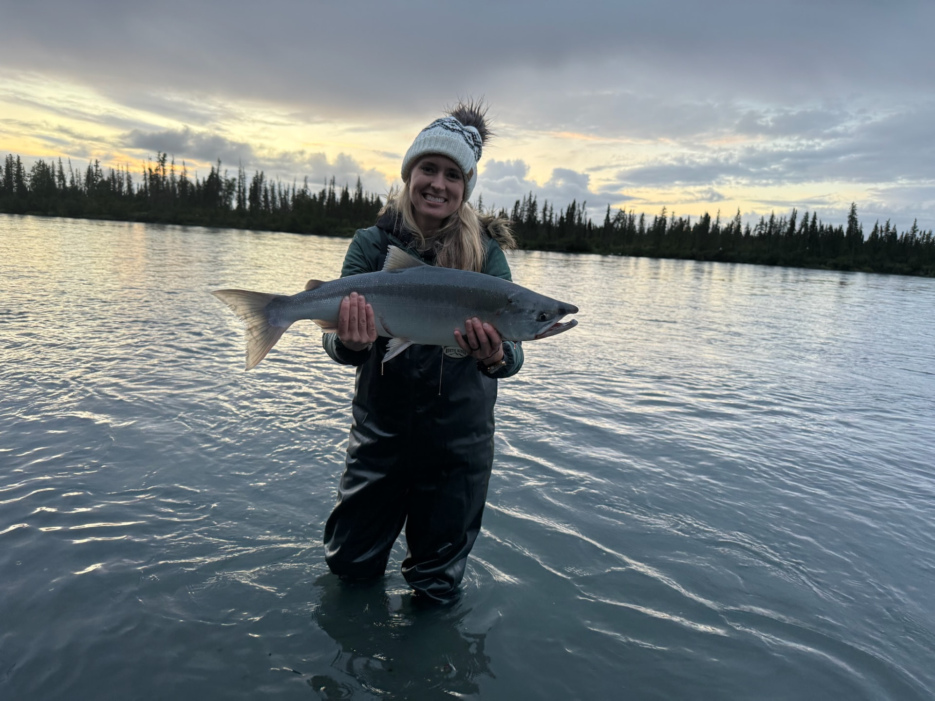 Angler with a sockeye at sunset on the Kenai