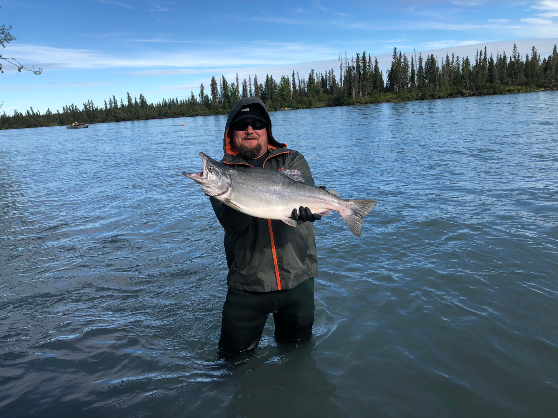 Angler holding a bright Kenai River salmon